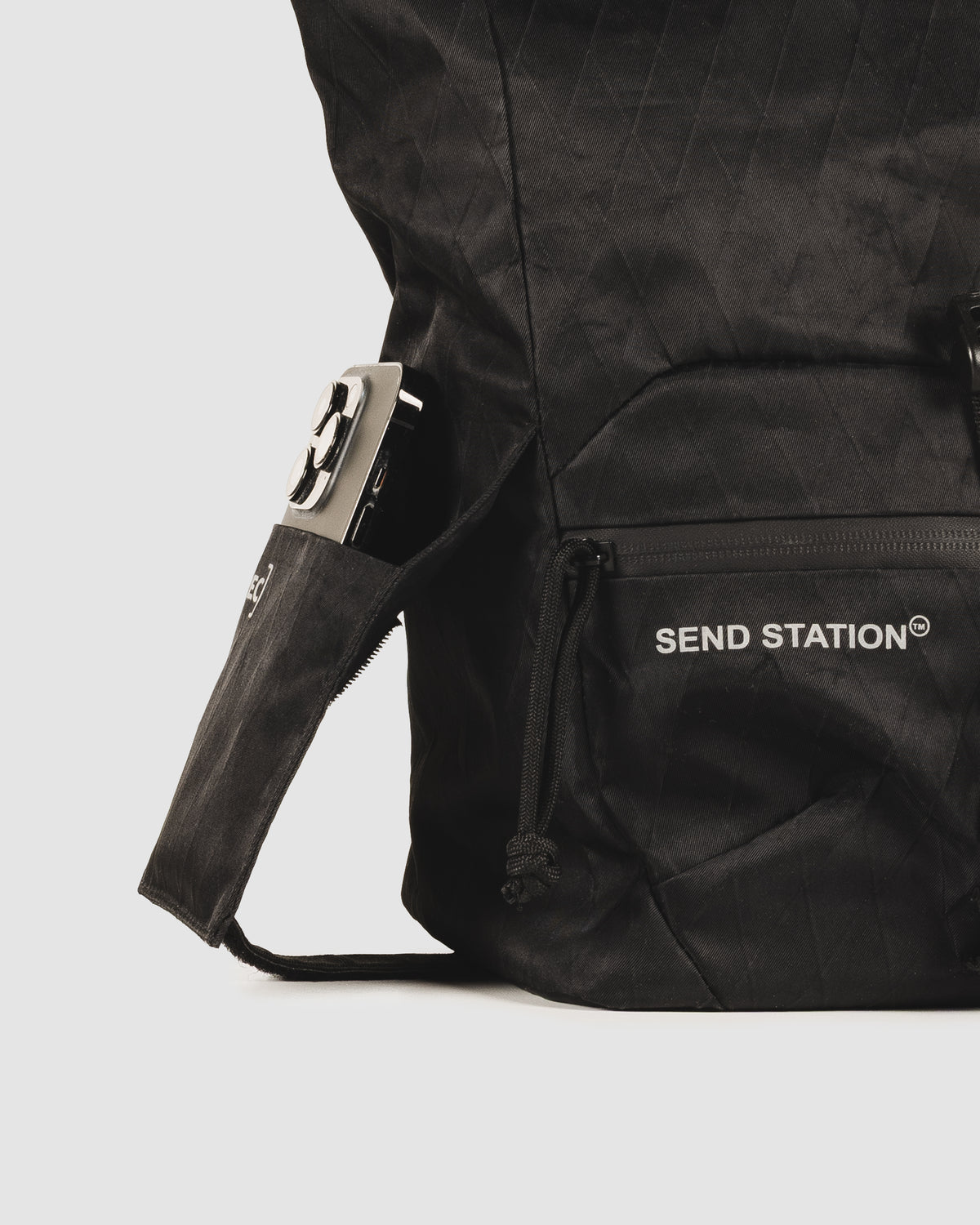 Close-up of the Send Station Bucket phone sleeve and zipped front pocket