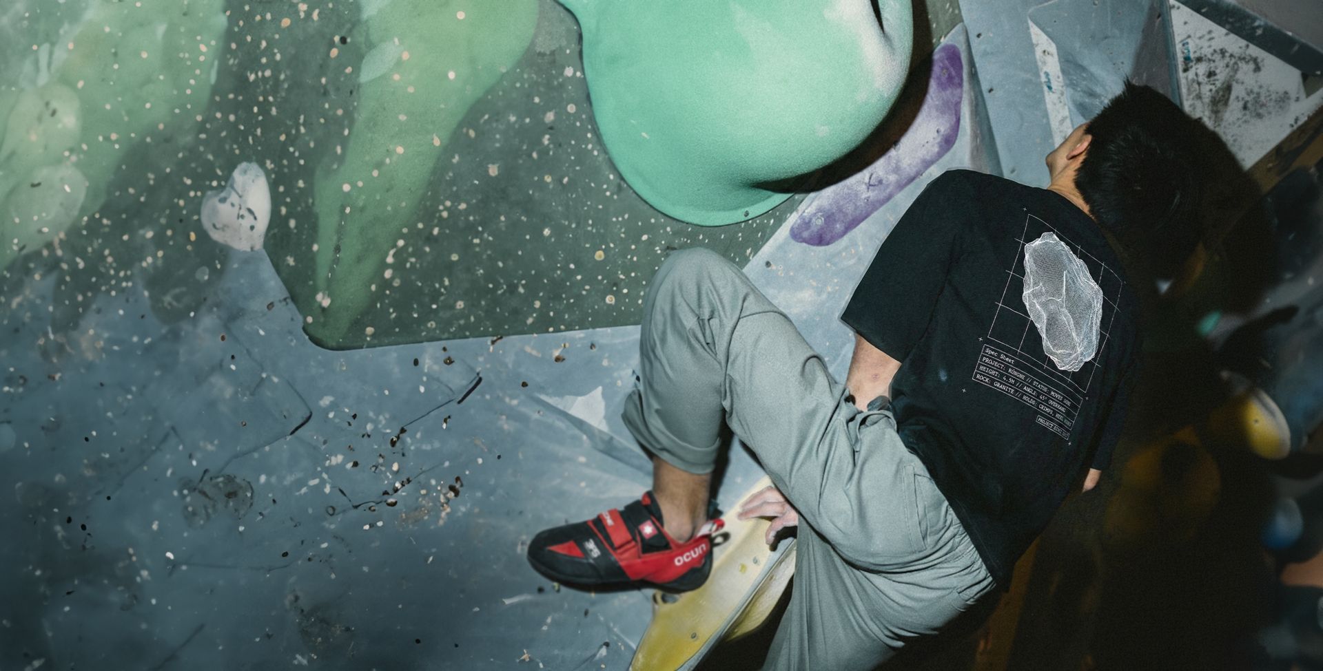 Climber on a gym bouldering wall