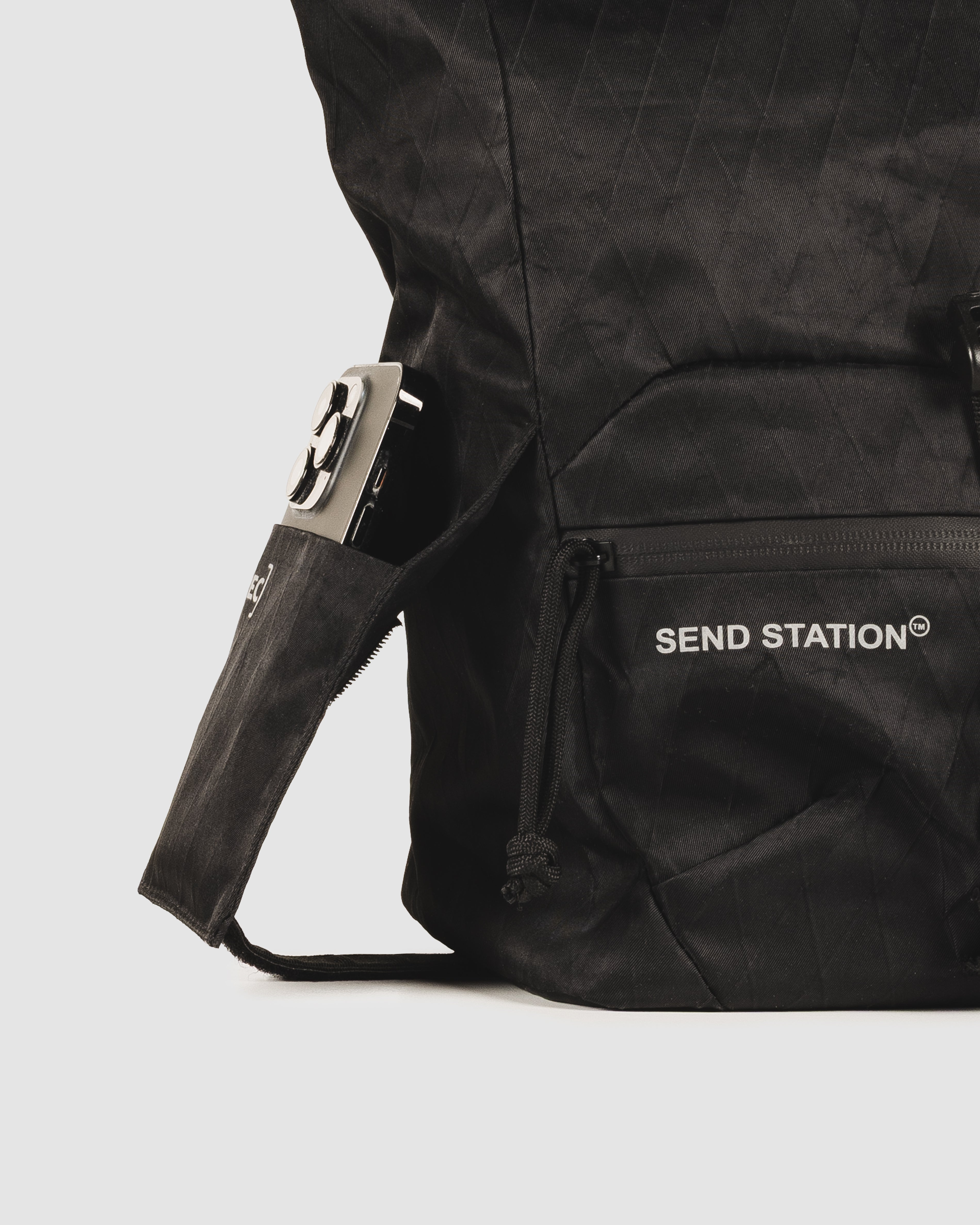 Close-up of the Send Station Bucket phone sleeve and zipped front pocket