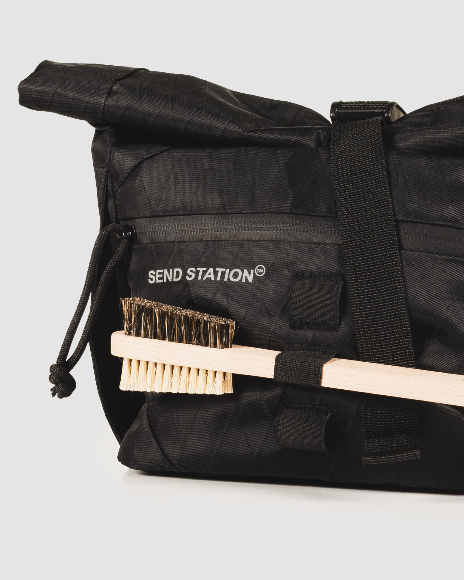 Brush held in the elastic loops on the front of the Send Station Bucket