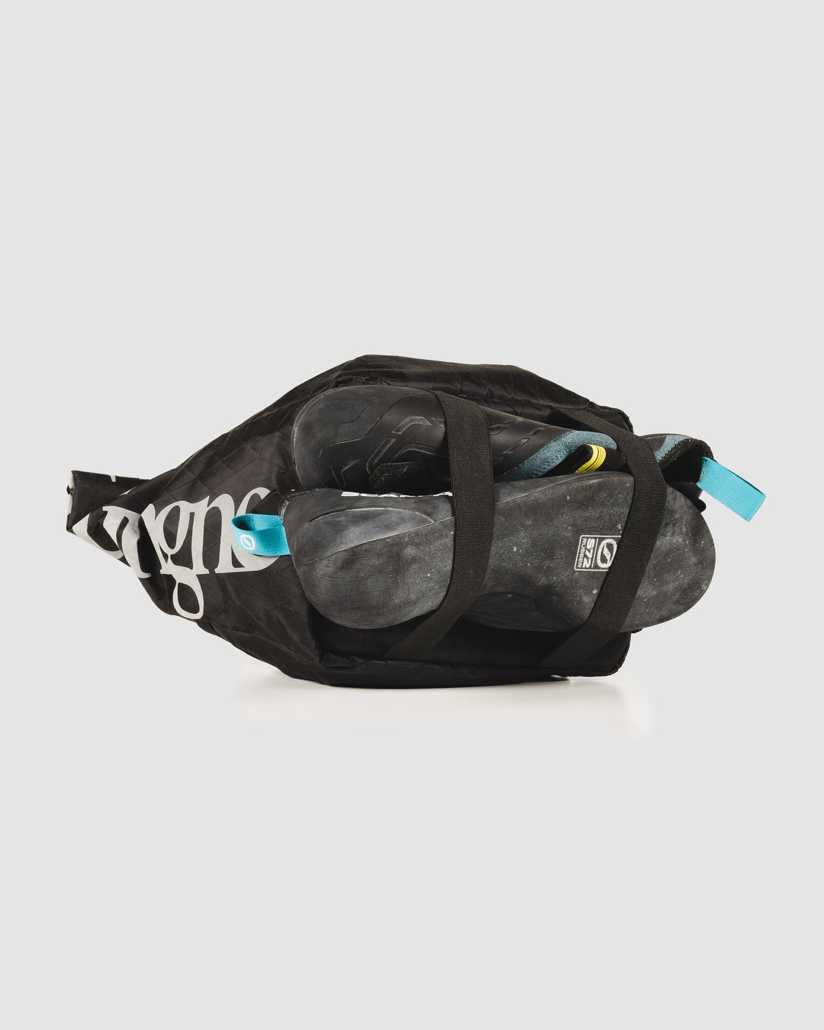 Send Station Bucket packed with climbing shoes, rope and brushes, seen from above