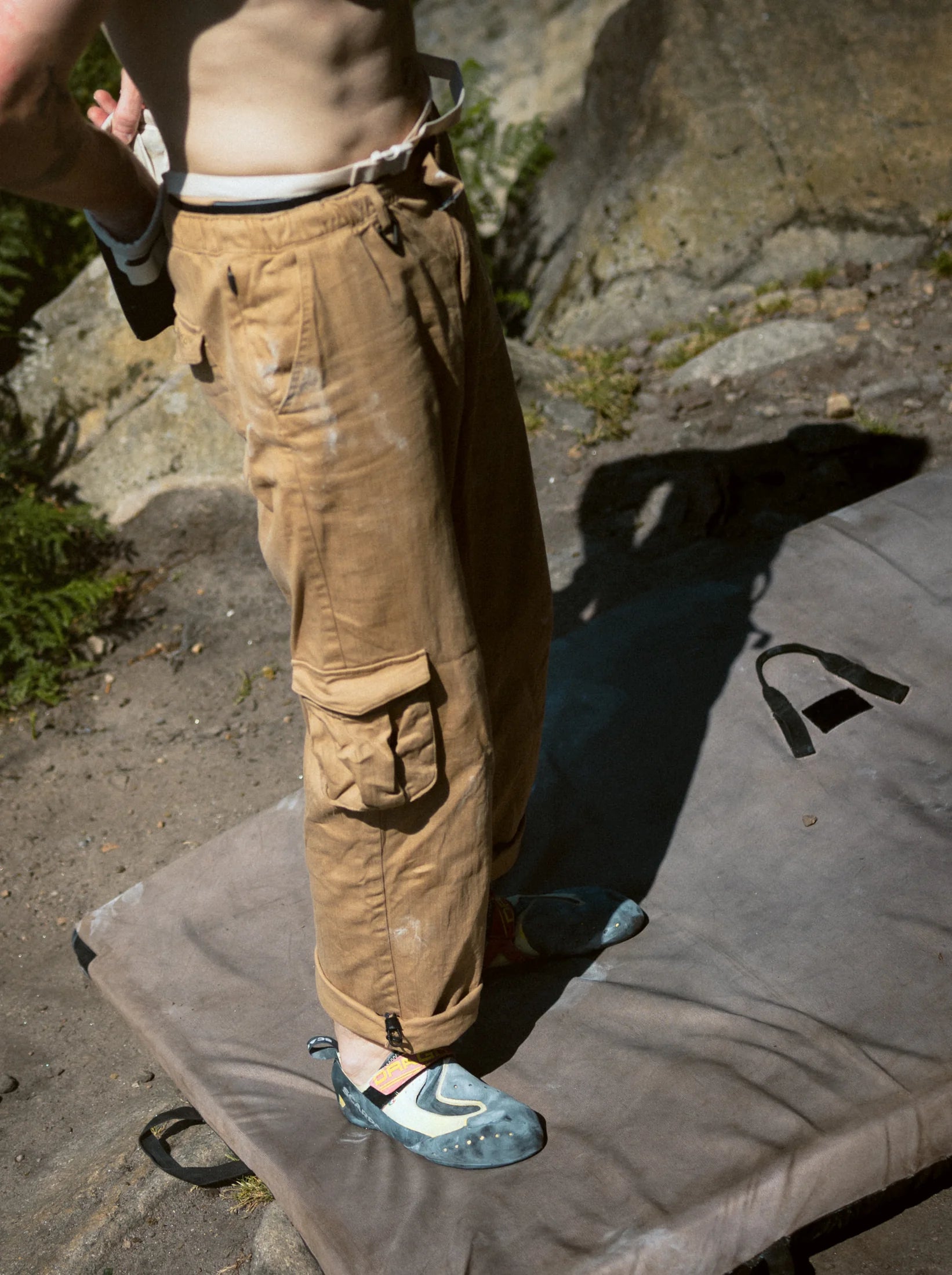 Highballer Utility Pants at full length, standing on a bouldering pad, the thigh pocket in shadow.